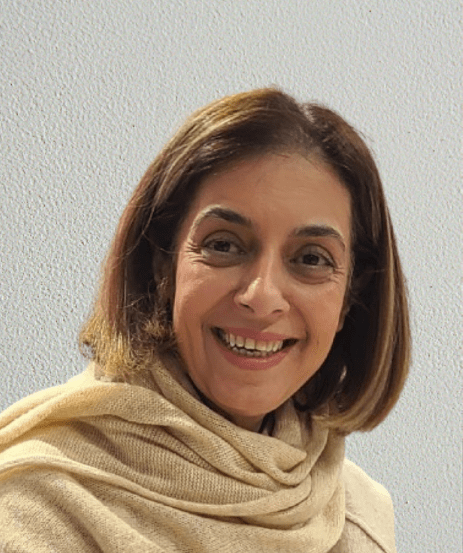 Maryam Tavosi, smiling with a light scarf, representing Scanbuild LLC, a home remodeling business focused on kitchen and bathroom renovations.